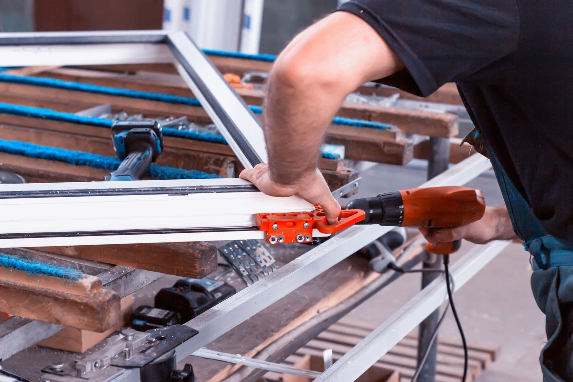 A worker prepares a window for installation.