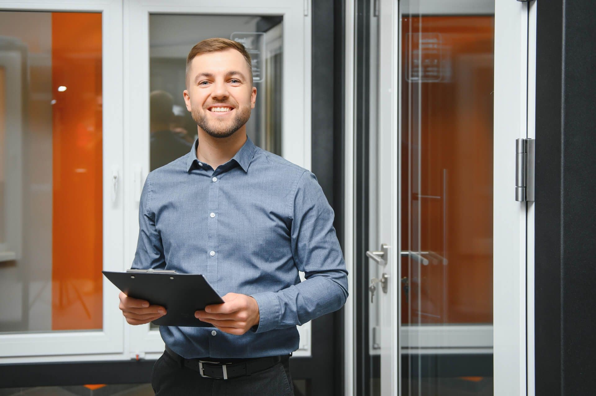 Man holding clipboard and smiling