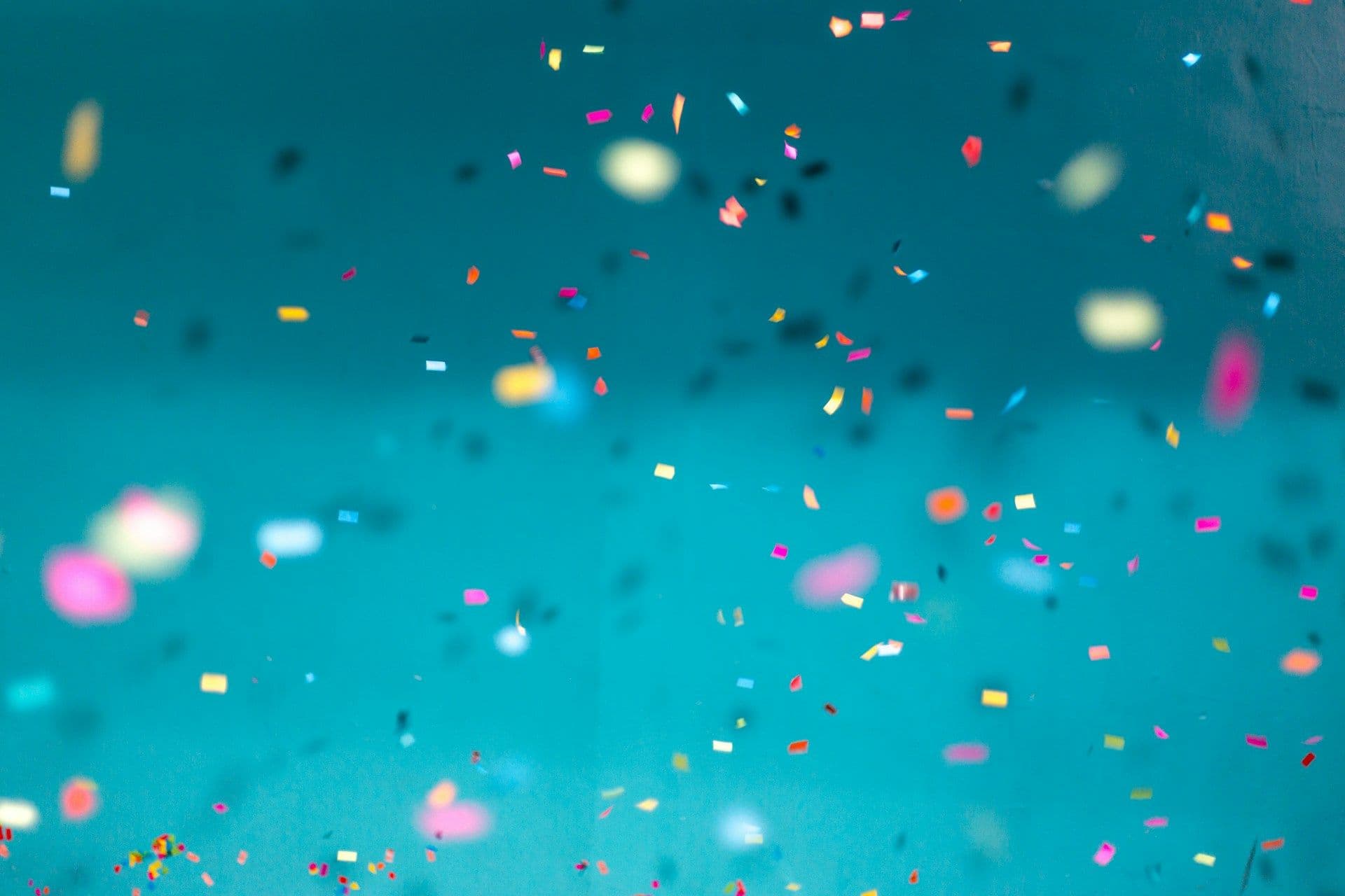 Confetti falls on a blue background.